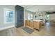 Bright kitchen with a central island, hardwood floors, and black appliances creates a modern and functional cooking space at 1011 Ashley Ave, Charleston, SC 29403