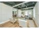 Open-concept living room with hardwood floors, stylish seating, and a black and white ceiling highlighting the home's inviting ambiance at 1011 Ashley Ave, Charleston, SC 29403