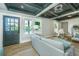 Bright living room with hardwood floors, panelled walls, and a detailed ceiling making it perfect for entertaining at 1011 Ashley Ave, Charleston, SC 29403