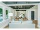 Cozy living room featuring stylish decor, hardwood floors, natural light, and an intricate black and white detailed ceiling at 1011 Ashley Ave, Charleston, SC 29403
