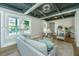 Elegant living room showcasing hardwood floors, panelled walls, and custom black and white ceiling details with recessed lighting at 1011 Ashley Ave, Charleston, SC 29403