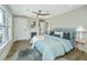 Inviting main bedroom with decorative fireplace, stylish ceiling fan and light-filled windows at 1011 Ashley Ave, Charleston, SC 29403