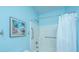 Bathroom featuring a tub/shower combo, grab bars, and a framed beach-themed print at 1022 Basildon Rd, Mount Pleasant, SC 29466