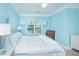Bright bedroom featuring light blue walls, white trim, and natural light from the window at 1022 Basildon Rd, Mount Pleasant, SC 29466