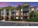 Exterior of building with brick facade, palm trees, covered balconies, and parking spaces at 1022 Basildon Rd, Mount Pleasant, SC 29466