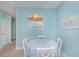 Charming dining area features a round table, white chairs, and a decorative wicker light fixture at 1022 Basildon Rd, Mount Pleasant, SC 29466