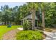 Community mail kiosk surrounded by lush landscaping, palm trees, and Adirondack chairs at 1022 Basildon Rd, Mount Pleasant, SC 29466