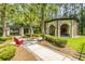 Community pavilion with brick fireplace, grill, and red Adirondack chairs on sidewalk pathway at 1022 Basildon Rd, Mount Pleasant, SC 29466