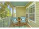 Inviting screened porch with cozy seating, offering a serene view of the surrounding trees and natural light at 1022 Basildon Rd, Mount Pleasant, SC 29466