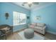 Light-filled sitting room featuring a striped couch, chair and ottoman, and bright blue walls at 1022 Basildon Rd, Mount Pleasant, SC 29466