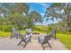 Backyard sitting area with fire pit and mature trees at 1032 Avenue Of Oaks, Charleston, SC 29407