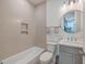 Bathroom with tile surround, storage vanity, and brushed fixtures at 1032 Avenue Of Oaks, Charleston, SC 29407