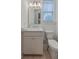 Well-lit half-bath with modern fixtures, stylish vanity, and a window for natural light at 1032 Avenue Of Oaks, Charleston, SC 29407