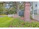 Avenue of Oaks community entrance featuring a brick pillar, lush landscaping, and a classic neighborhood sign at 1032 Avenue Of Oaks, Charleston, SC 29407