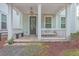 Inviting front porch featuring a cozy bench swing, creating a relaxing and welcoming entrance to the home at 1032 Avenue Of Oaks, Charleston, SC 29407
