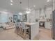 Bright, open kitchen with island, white cabinetry, stainless steel appliances, and modern pendant lighting at 1032 Avenue Of Oaks, Charleston, SC 29407