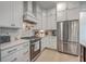 Modern kitchen featuring white cabinets, stainless steel appliances, and stylish backsplash at 1032 Avenue Of Oaks, Charleston, SC 29407