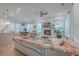 Bright living room features fireplace, ceiling fan, ample seating and view to dining area with modern decor at 1032 Avenue Of Oaks, Charleston, SC 29407