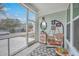 Relaxing screened-in porch offering outdoor living space with comfortable seating and decorative elements at 1032 Avenue Of Oaks, Charleston, SC 29407