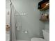 Bathroom with gray walls, open shelves, and bath with shower and towel hooks at 106 Abigale Ln, Summerville, SC 29483