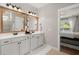Well-lit bathroom with double sink vanity, framed mirrors, and neutral finishes at 106 Abigale Ln, Summerville, SC 29483