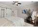 Cozy bedroom features sliding barn door, ceiling fan, and soothing decor at 106 Abigale Ln, Summerville, SC 29483