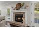 Charming fireplace with brick surround and white mantle, next to a door leading to the pool at 106 Abigale Ln, Summerville, SC 29483