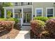 Inviting front porch with white columns and decorative shrubbery at 106 Abigale Ln, Summerville, SC 29483