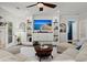 Bright living room with a beach view on the TV, stylish decor and comfortable seating at 106 Abigale Ln, Summerville, SC 29483