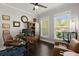 Well-lit home office with a desk, chair, bookcase, and two large windows at 106 Abigale Ln, Summerville, SC 29483