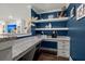 Stylish home office area with built-in shelves, granite countertop, and blue accent wall at 106 Abigale Ln, Summerville, SC 29483
