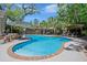 Inviting backyard pool with an umbrella covered lounge area, a covered deck with dining furniture, and privacy fence at 106 Abigale Ln, Summerville, SC 29483
