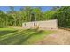 Exterior shot of home with traditional siding, small porch, green lawn, and surrounded by mature trees at 1086 Arrowhead Rd, Saint Stephen, SC 29479