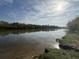 Scenic river view with a tranquil waterway reflecting the sky, surrounded by lush greenery at 1086 Arrowhead Rd, Saint Stephen, SC 29479