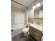 Bathroom features a shower-tub combo, modern vanity with storage, and modern lighting at 109 Alexander St, Walterboro, SC 29488