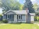 Quaint single-story home showcasing a newly painted exterior, brick chimney, and a welcoming front porch at 109 Alexander St, Walterboro, SC 29488