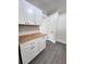 Kitchen boasts custom wood countertops and white cabinetry with modern hardware at 109 Alexander St, Walterboro, SC 29488