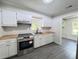 Updated kitchen with stainless steel appliances, butcher block countertops, and ample storage space at 109 Alexander St, Walterboro, SC 29488