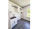 This light and bright laundry room has upper cabinets and a stainless steel sink at 109 Alexander St, Walterboro, SC 29488