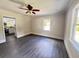 Bright living room featuring hardwood floors, modern ceiling fan, and natural light from large windows at 109 Alexander St, Walterboro, SC 29488