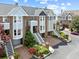 Beautiful aerial shot showcases townhomes with garden landscaping and attached garages at 11 Harleston Pl, Charleston, SC 29401