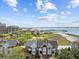 Aerial view of a residential community with waterfront views, surrounded by lush trees at 11 Harleston Pl, Charleston, SC 29401