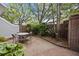 Charming brick patio with a dining table, surrounded by lush greenery, providing a private outdoor space at 11 Harleston Pl, Charleston, SC 29401