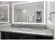 Modern bathroom with double sink vanity, decorative backsplash, and large LED-lit mirror at 11 Harleston Pl, Charleston, SC 29401