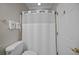 Bright bathroom featuring a white shower curtain, neutral wall color, and decorative gold accents at 11 Harleston Pl, Charleston, SC 29401
