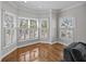 Bright bay window area featuring multiple windows with white shutters, bringing natural light into the living space at 11 Harleston Pl, Charleston, SC 29401