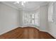 Bright bedroom featuring hardwood floors, a large bay window with shutters, and neutral walls at 11 Harleston Pl, Charleston, SC 29401