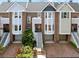 Charming brick townhomes with individual entrances, gardens, and garages enhance curb appeal at 11 Harleston Pl, Charleston, SC 29401