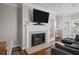 Cozy living room fireplace with traditional white mantle and decoratively tiled hearth in neutral shades at 11 Harleston Pl, Charleston, SC 29401