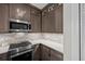 Contemporary kitchen showcasing stainless steel oven and microwave, plus beautiful stone backsplash at 11 Harleston Pl, Charleston, SC 29401